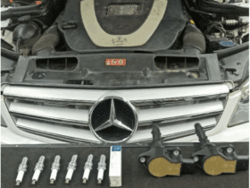 Mercedes-Benz engine with removed spark plugs and ignition coils displayed for misfire repair