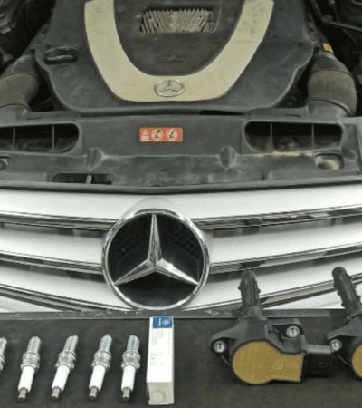 Mercedes-Benz engine with removed spark plugs and ignition coils displayed for misfire repair