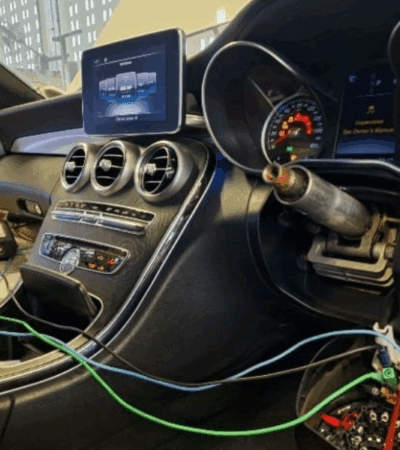 Mercedes-Benz interior showing diagnostic tools connected to the ignition and dashboard warning lights during no-start troubleshooting.
