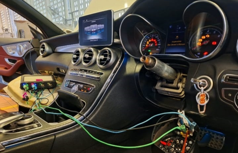 Mercedes-Benz interior showing diagnostic tools connected to the ignition and dashboard warning lights during no-start troubleshooting.